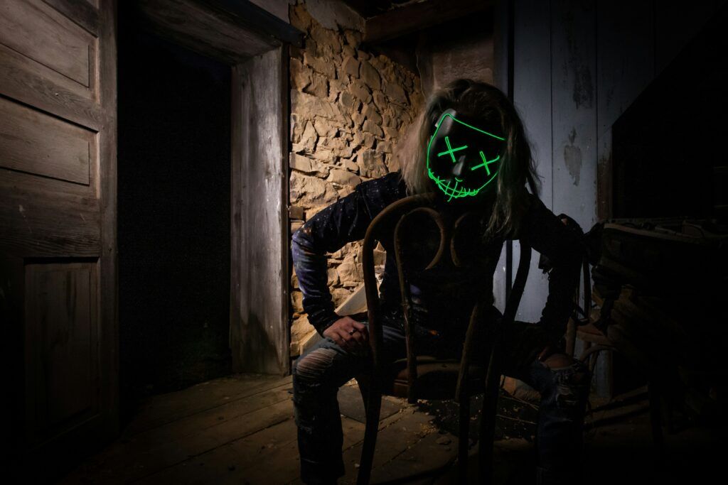 a scary guy in a dark room to represent slasher movies