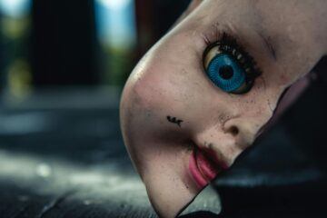 a broken doll face to represent creepy dolls