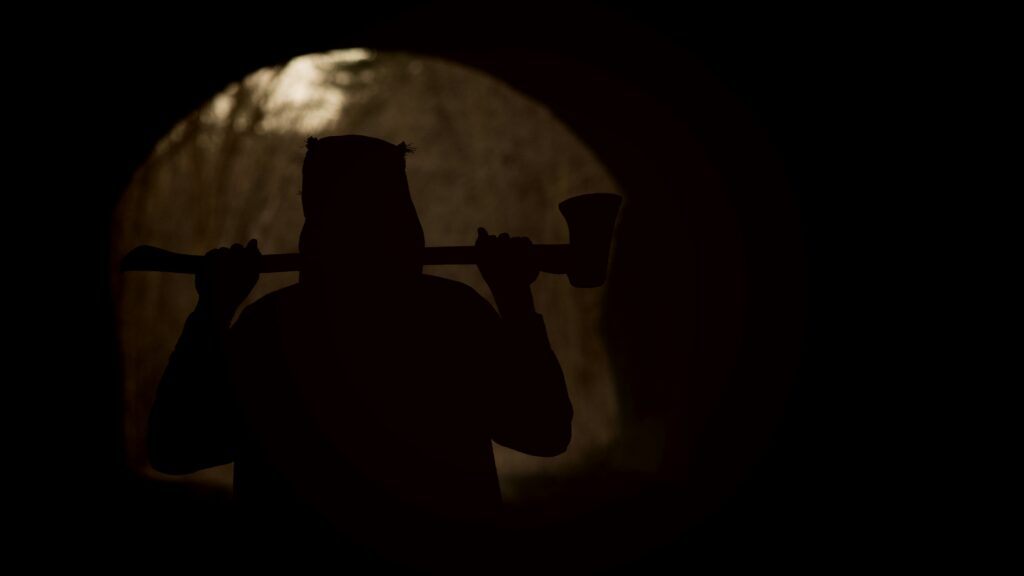 a dark figure with an axe to represent slasher movies 