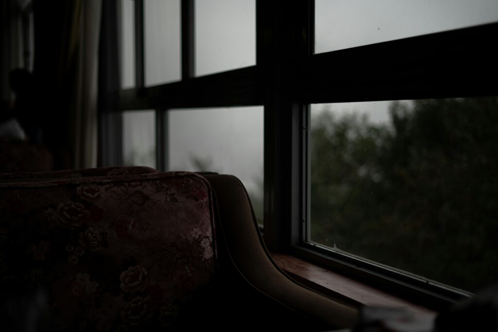 a spooky chair by the window to represent cozy horror writing prompts