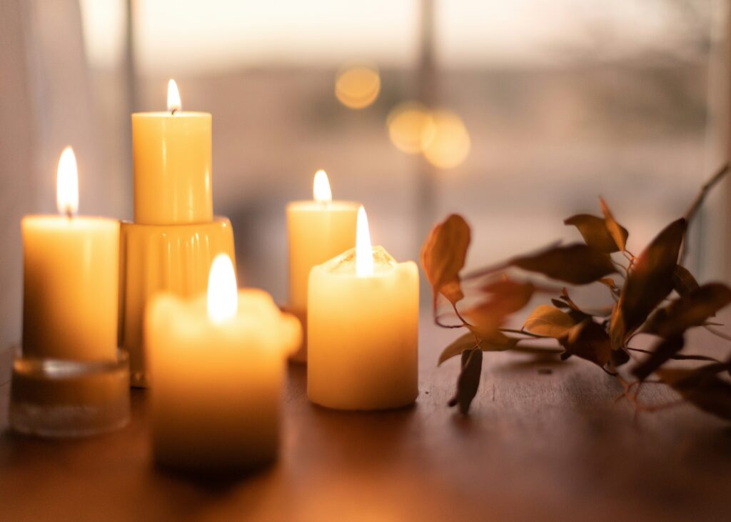 some candles and leaves to represent cozy horror